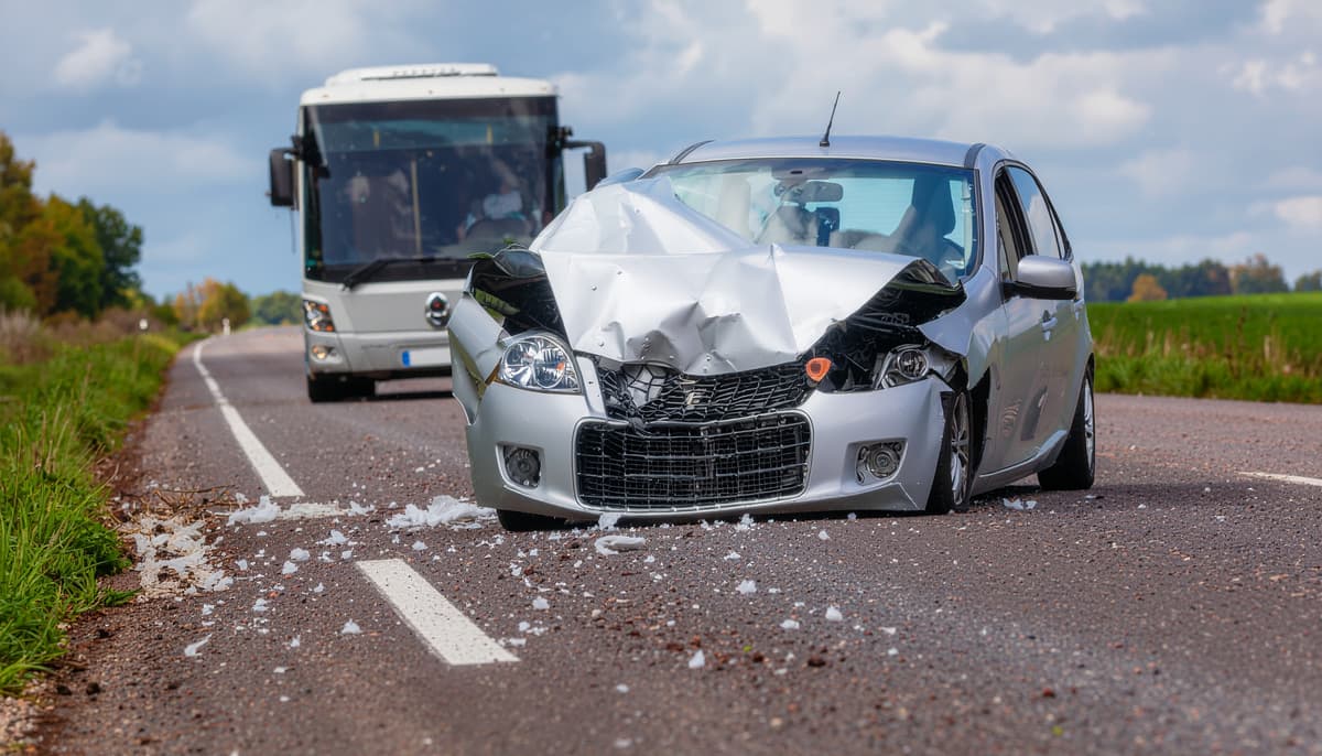 Bus accident scene showing collision between bus and car
